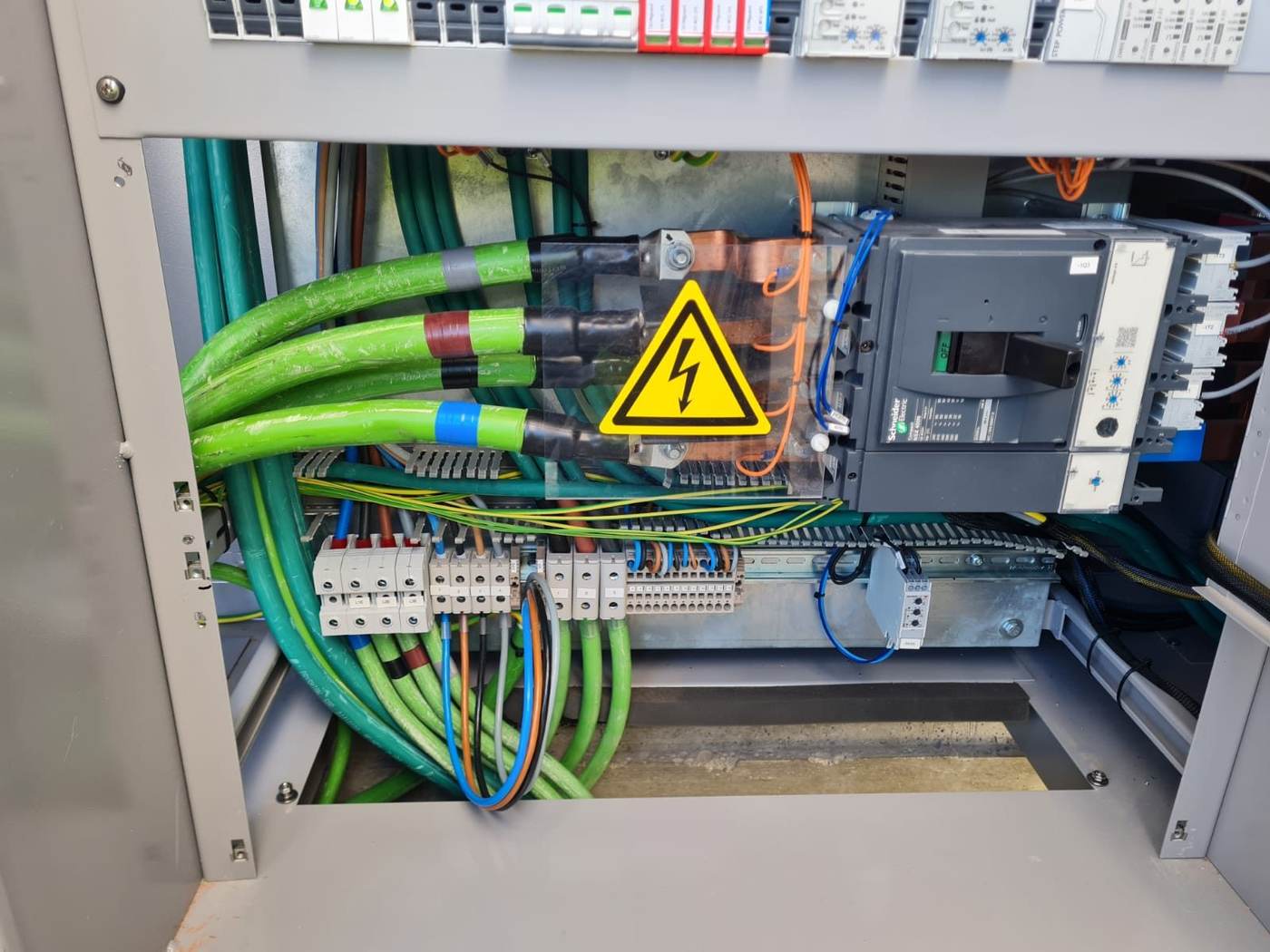 Interior de un cuadro eléctrico con el interruptor de cabecera y los cables de potencia